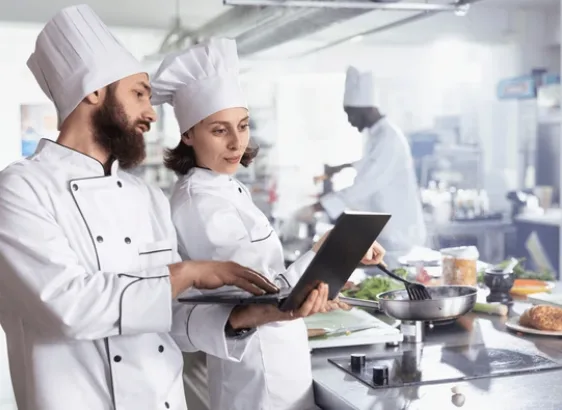 Chef working with a digital recipe screen